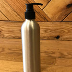 Aluminum bottles with lotion, soap, and fine mist spray pumps from OTB Refills, showing sleek, reusable containers with dispensing nozzles.