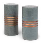 Salt and pepper stone shakers with carved patterns by Ten Thousand Villages, showcasing a rustic, handcrafted design.