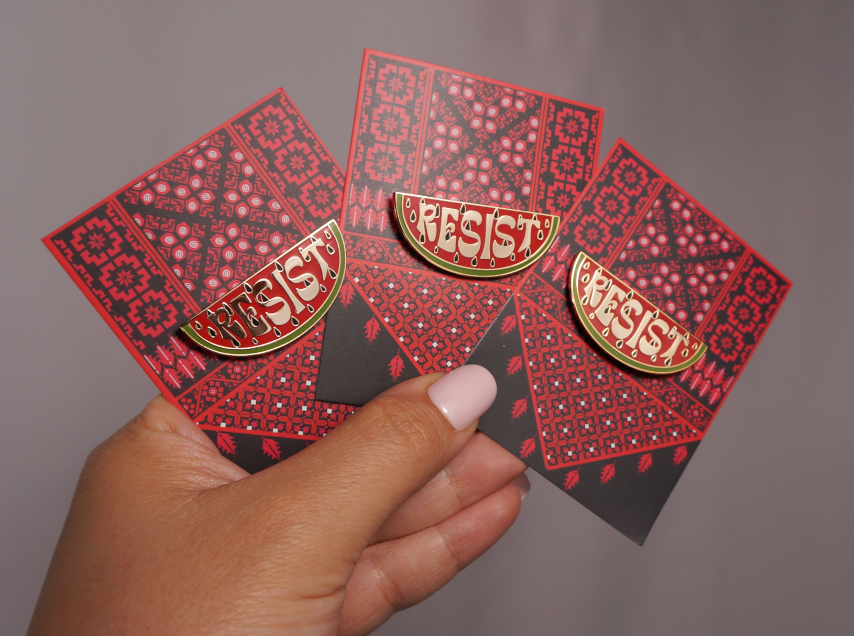 Resist Watermelon enamel pin by Stitch4pali featuring a colorful watermelon design on a metal pin backing.