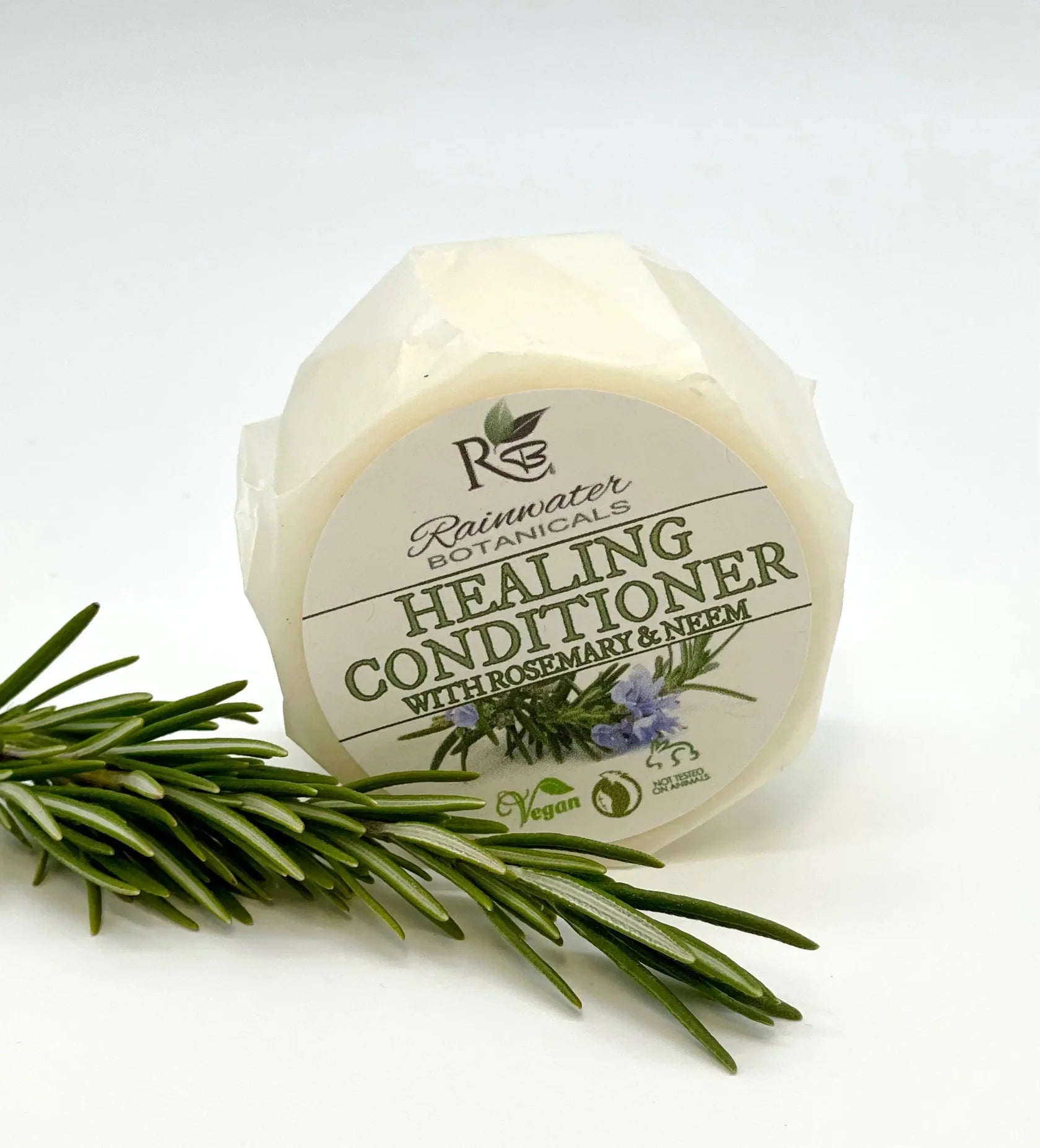 Rainwater Botanicals healing solid conditioner bar for zero-waste hair care, shown in a natural, eco-friendly packaging.