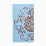 Assorted small Jotter notebooks by Blackbird Letterpress with colorful covers stacked together on a wooden surface.