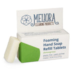 Meliora foaming hand soap refill tablets in a clear container, ready to be dissolved into soap for handwashing.
