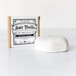 ScentCerae Hair Rocks natural shampoo bar with textured surface and earthy packaging, designed for gentle hair cleansing.