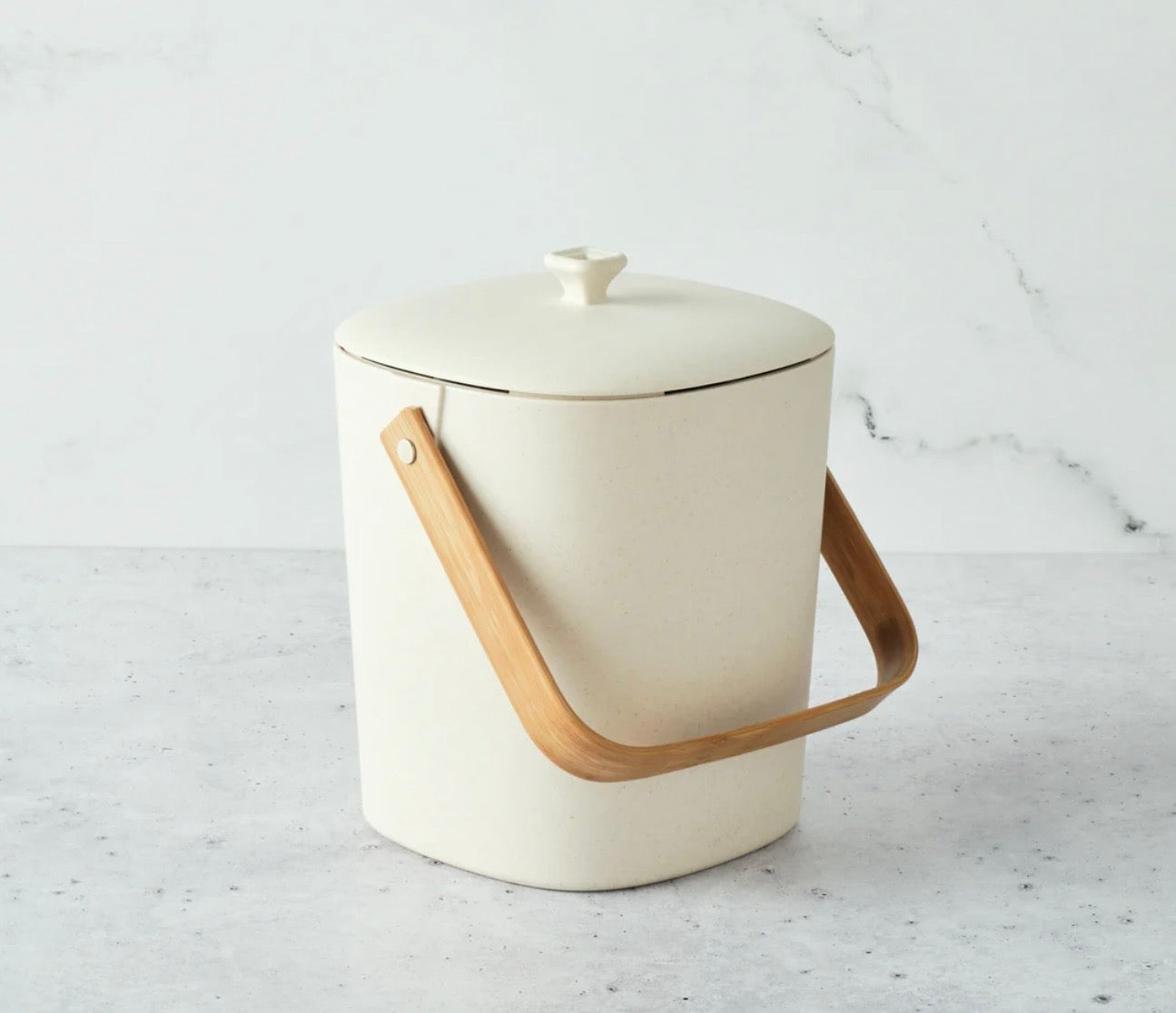 Bamboozle countertop composter in assorted colors, compact design with bamboo lid and air vents for eco-friendly kitchen waste recycling.