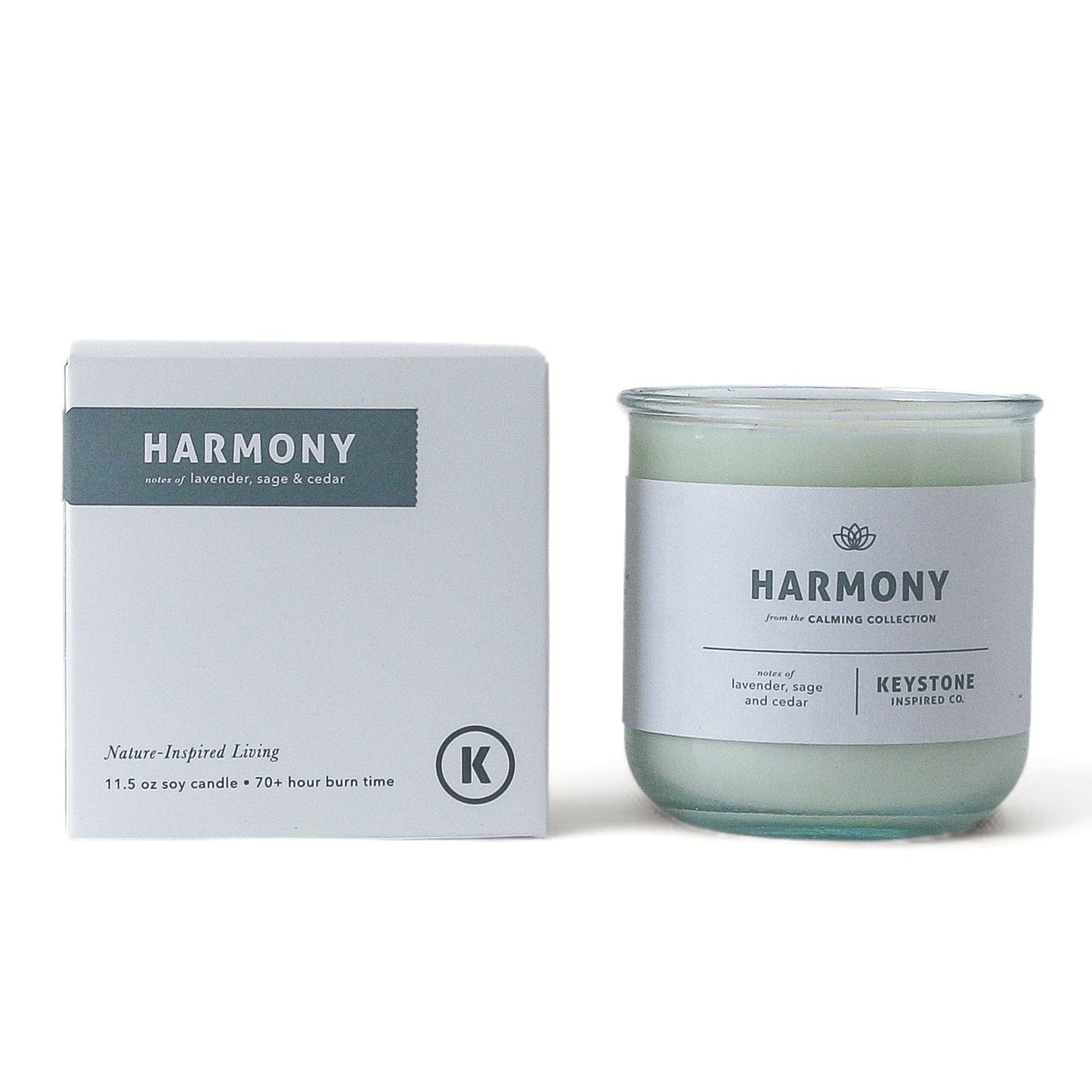11.5 oz Keystone Inspired soy candle in a clear glass jar, with a lit wick and soft glow, perfect for home décor and ambiance.