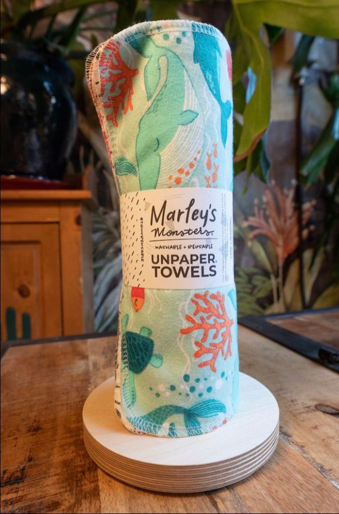 Rolled Marley’s UNpaper Towels by Marley's Monsters, reusable eco-friendly cloth towels on a white background.