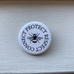 Off the Bottle Refill Shop Freethinker Paper Co buttons featuring colorful, round designs on a white background.