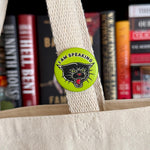 Mourning Breath Button Pin with black and white design, featuring a somber motif, on a plain background.