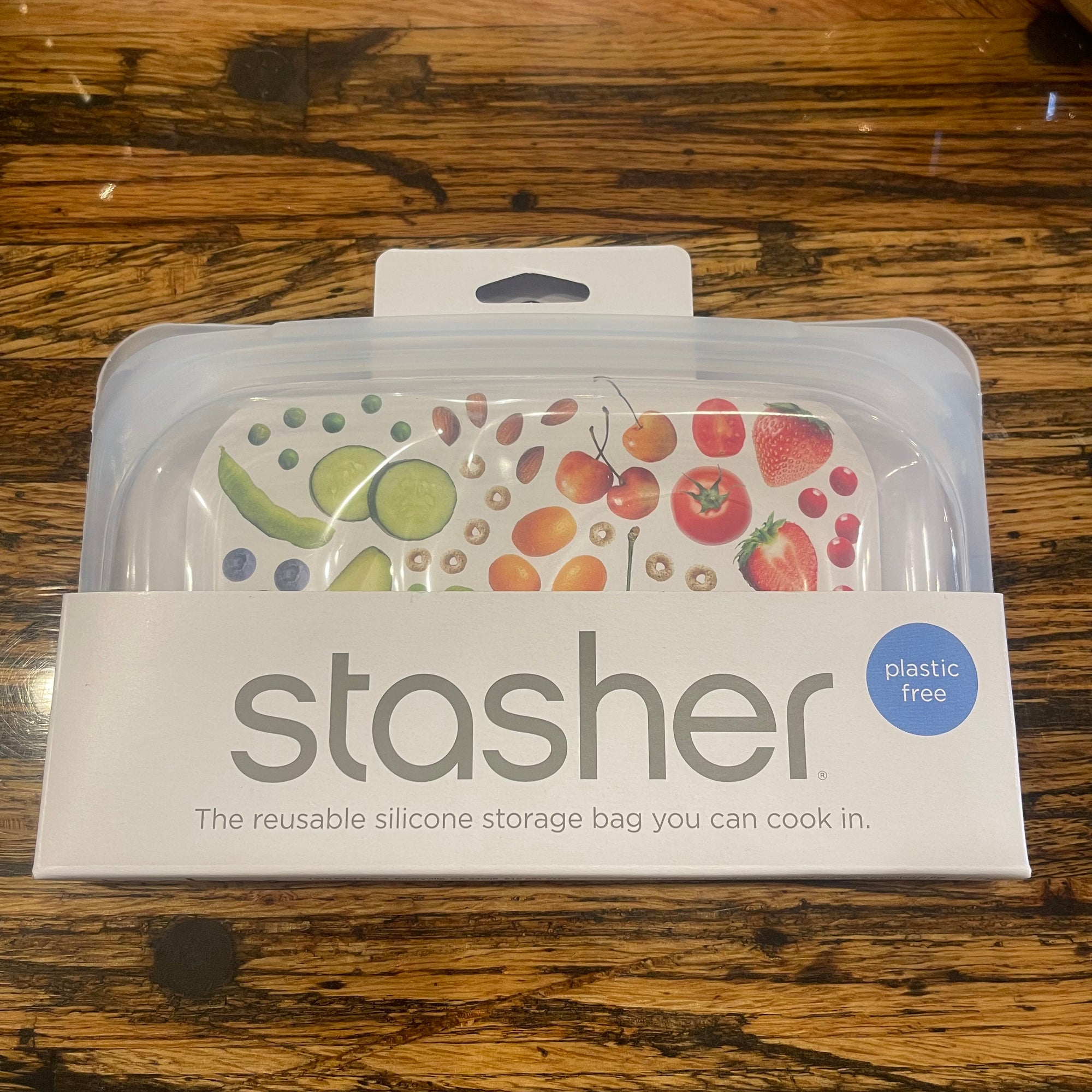Stasher Snack Size reusable silicone storage bag with clear body and teal seal, ideal for snacks and small items.