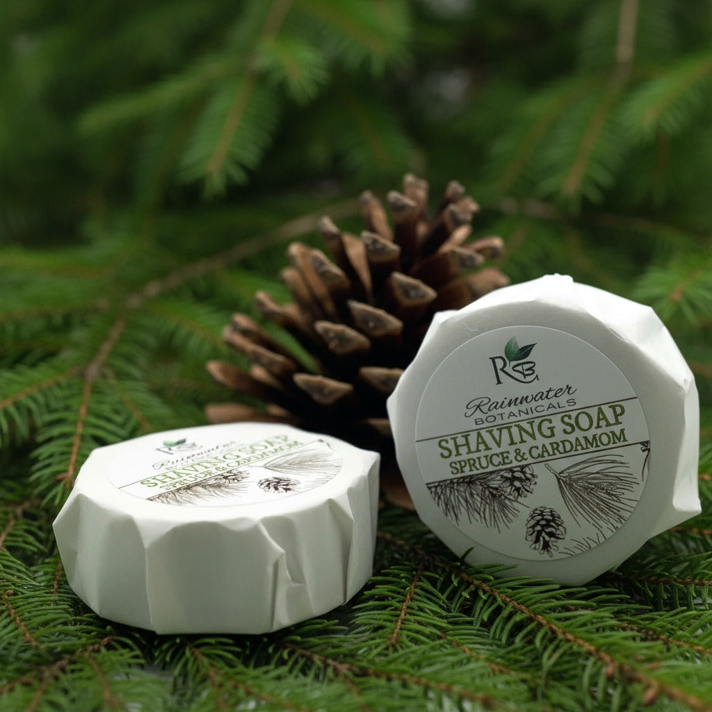 Rainwater Botanicals shave soap in a round container with a creamy lather, ready for a close shave.