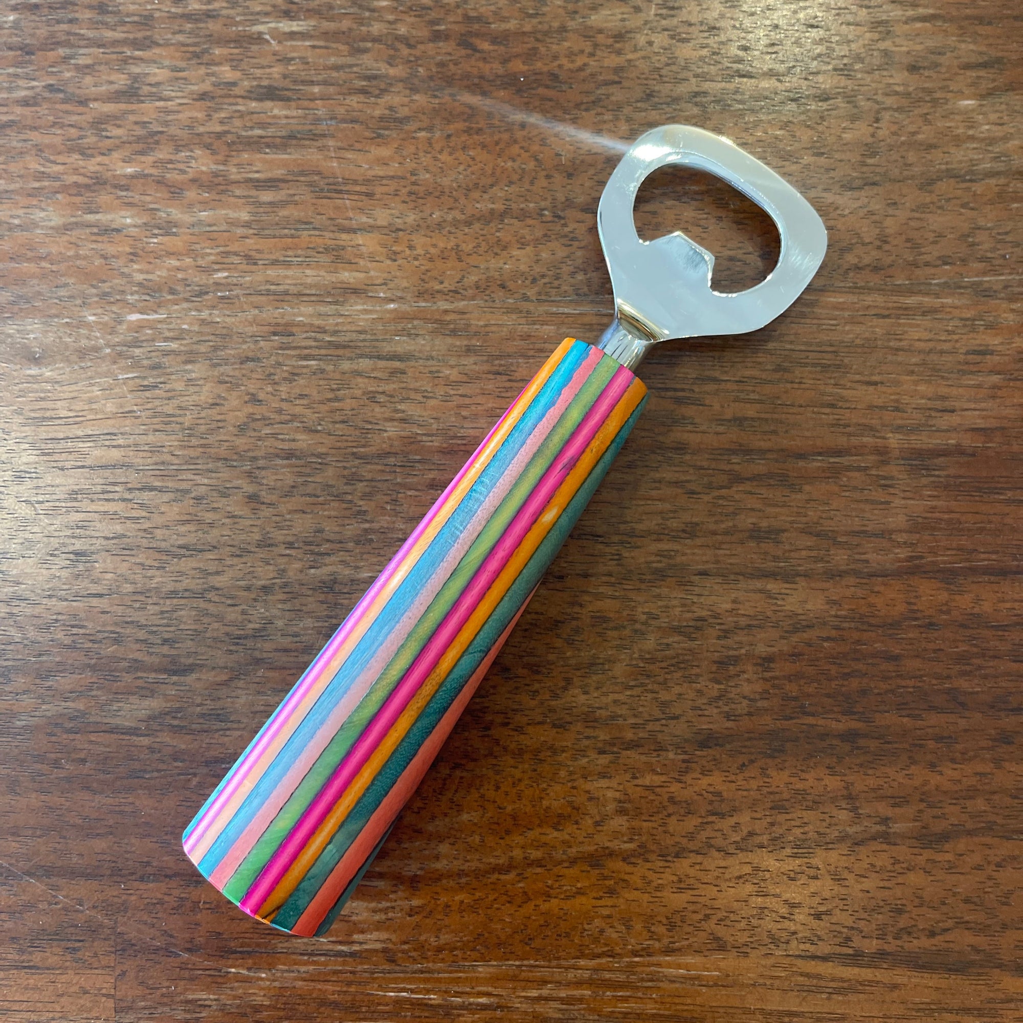 Off the Bottle Refill Shop Ten Thousand Villages bottle opener with a sturdy metal design and decorative handle.