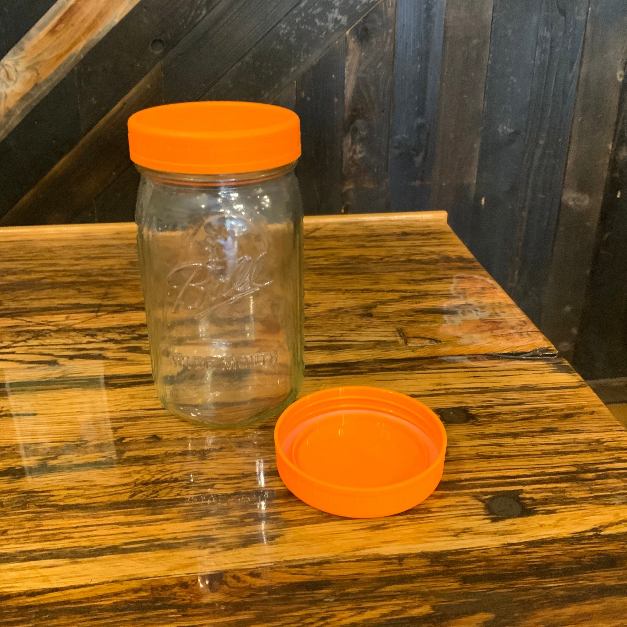 Assorted plastic mason jar lids by OTB Refills, featuring various colors and sizes for secure jar sealing.