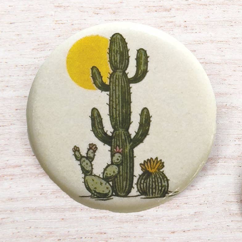 Counter Couture Button showing a close-up of a decorative fabric-covered button with detailed stitching and vibrant pattern.