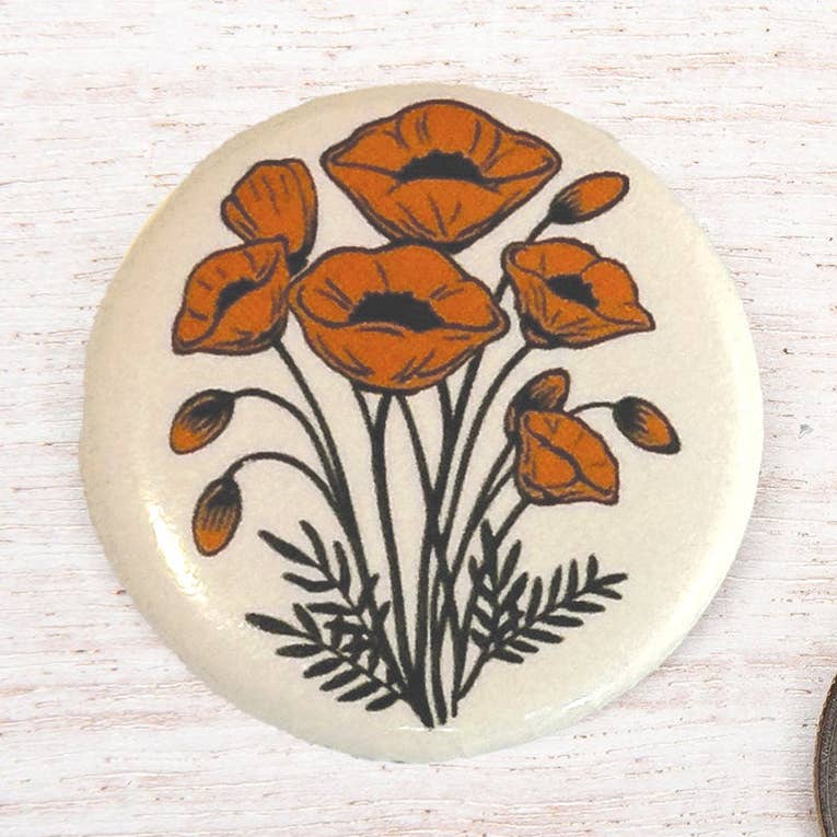 Counter Couture button with intricate design, featuring a polished finish and detailed craftsmanship, ideal for fashion or sewing projects.