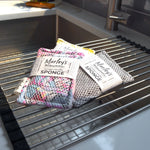 Reusable washable sponge by Marley's Monsters, showing a soft, eco-friendly cleaning sponge with a textured surface.