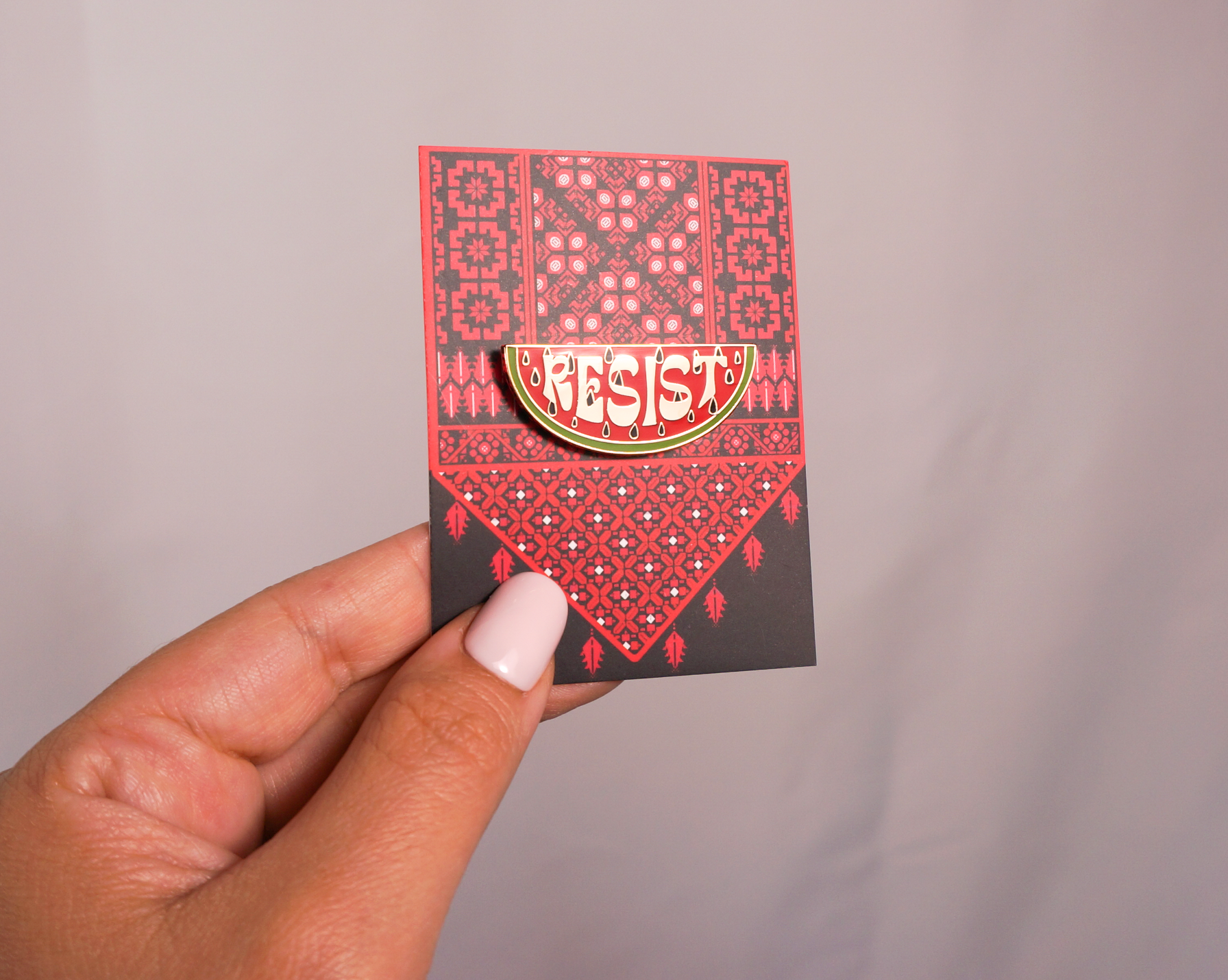 Resist Watermelon enamel pin by Stitch4pali featuring a colorful watermelon slice design on a metal pin backing.