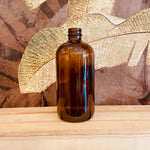 Amber glass Boston bottles by Premium Vials in 32 oz, 16 oz, and 8 oz sizes, showing sleek, amber-colored glass containers with black caps.