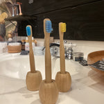 Kids bamboo toothbrush by OTB Refills with green bamboo handle and soft bristles, designed for gentle oral care.