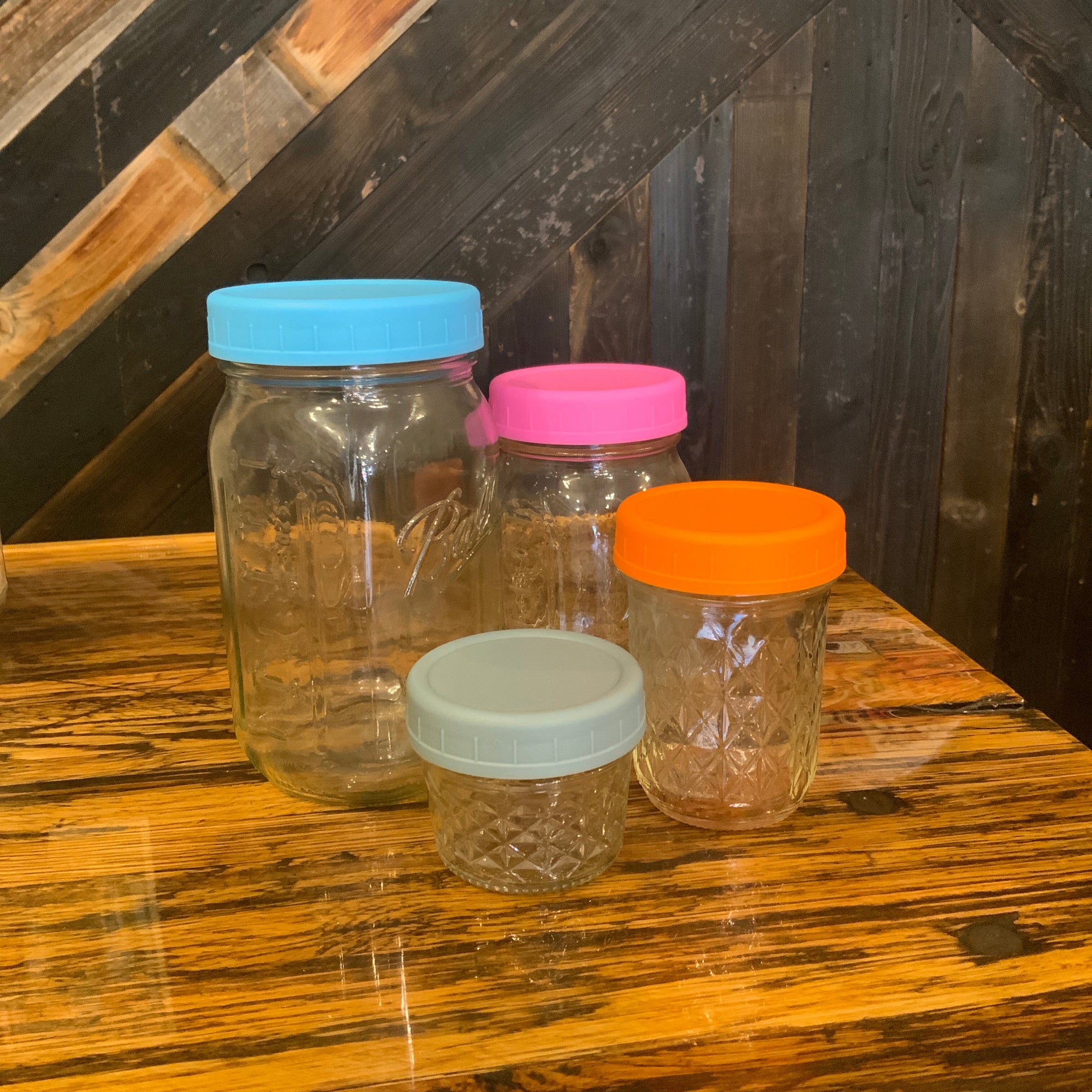 Assorted plastic mason jar lids by OTB Refills, showing various sizes and colors for sealing mason jars.