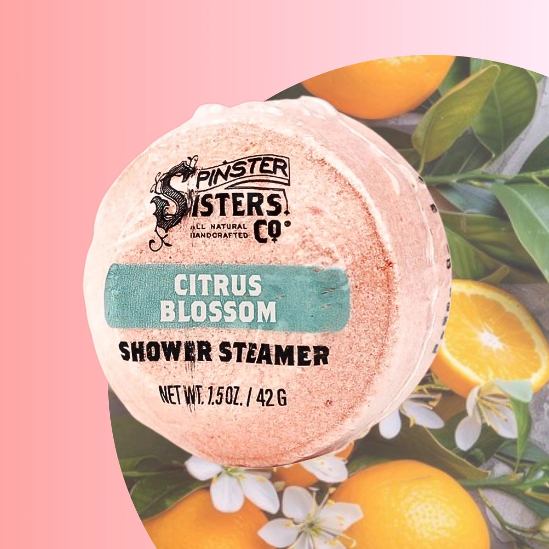 Spinster Sisters citrus shower steamers emitting steam in a bathroom setting for a refreshing aromatherapy experience.